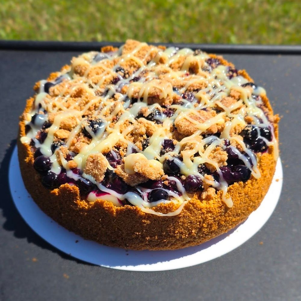 Blueberry crumble cheesecake with a white drizzle